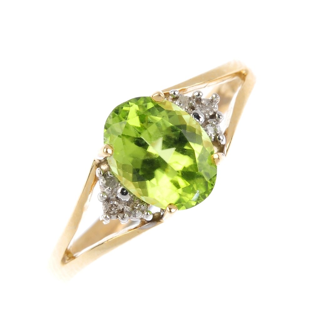 A 9ct gold peridot and diamond ring. The oval-shape (1 of 3)