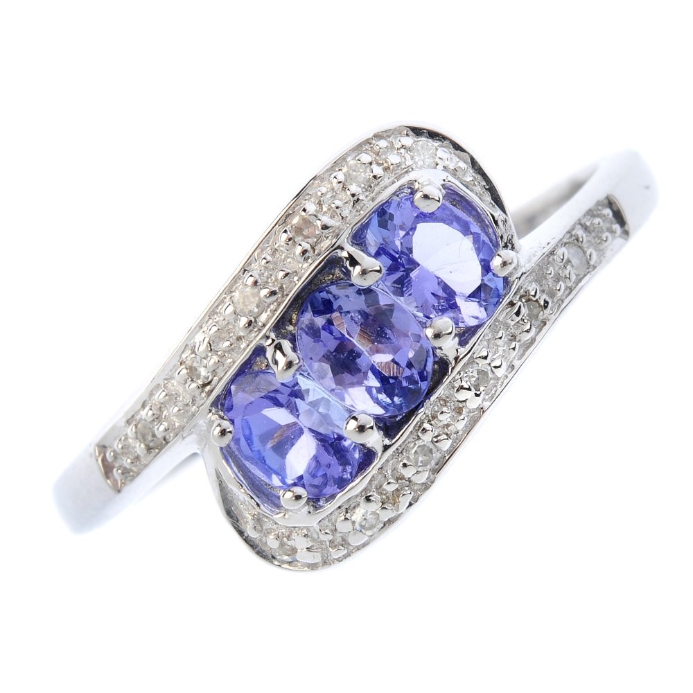 A 9ct gold tanzanite and diamond dress ring. Designed (1 of 3)