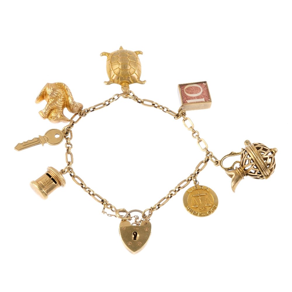 A 9ct gold charm bracelet. The fancy-link bracelet, (1 of 2)