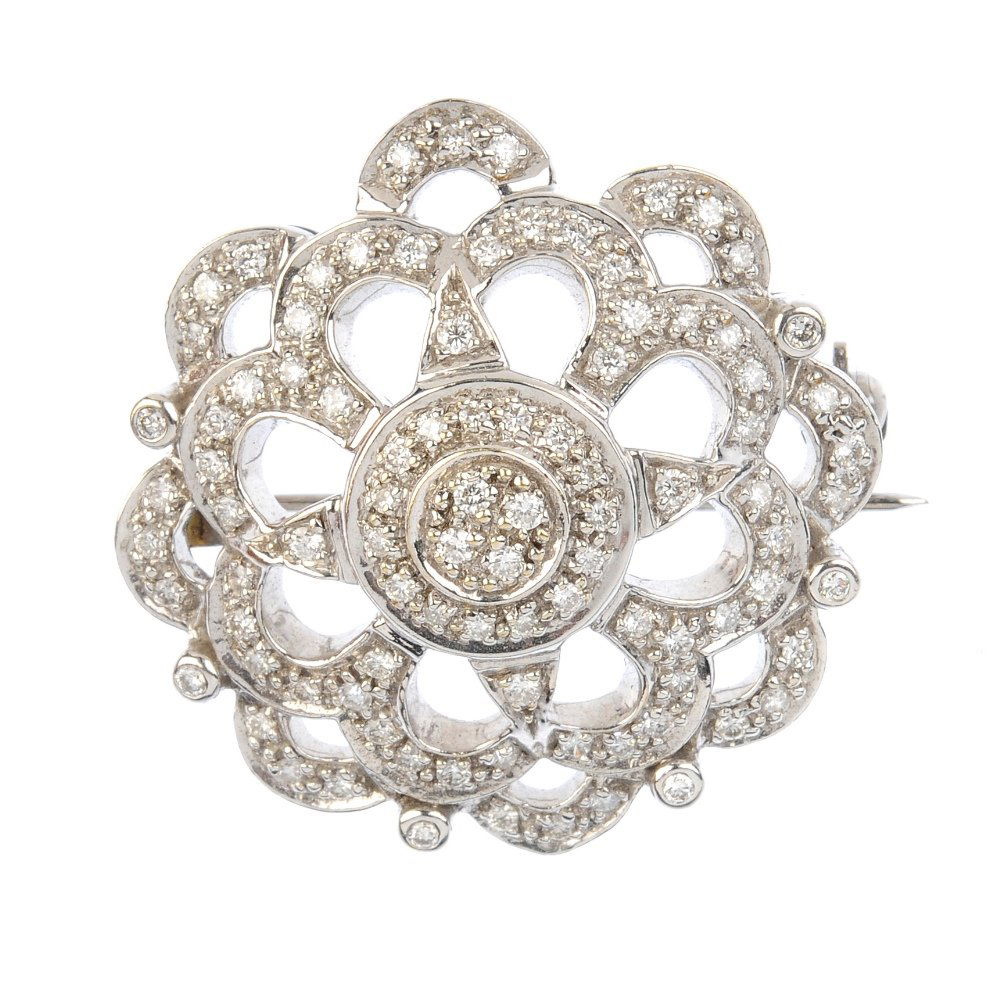 A 9ct gold diamond brooch. The pave-set diamond disc, (1 of 2)