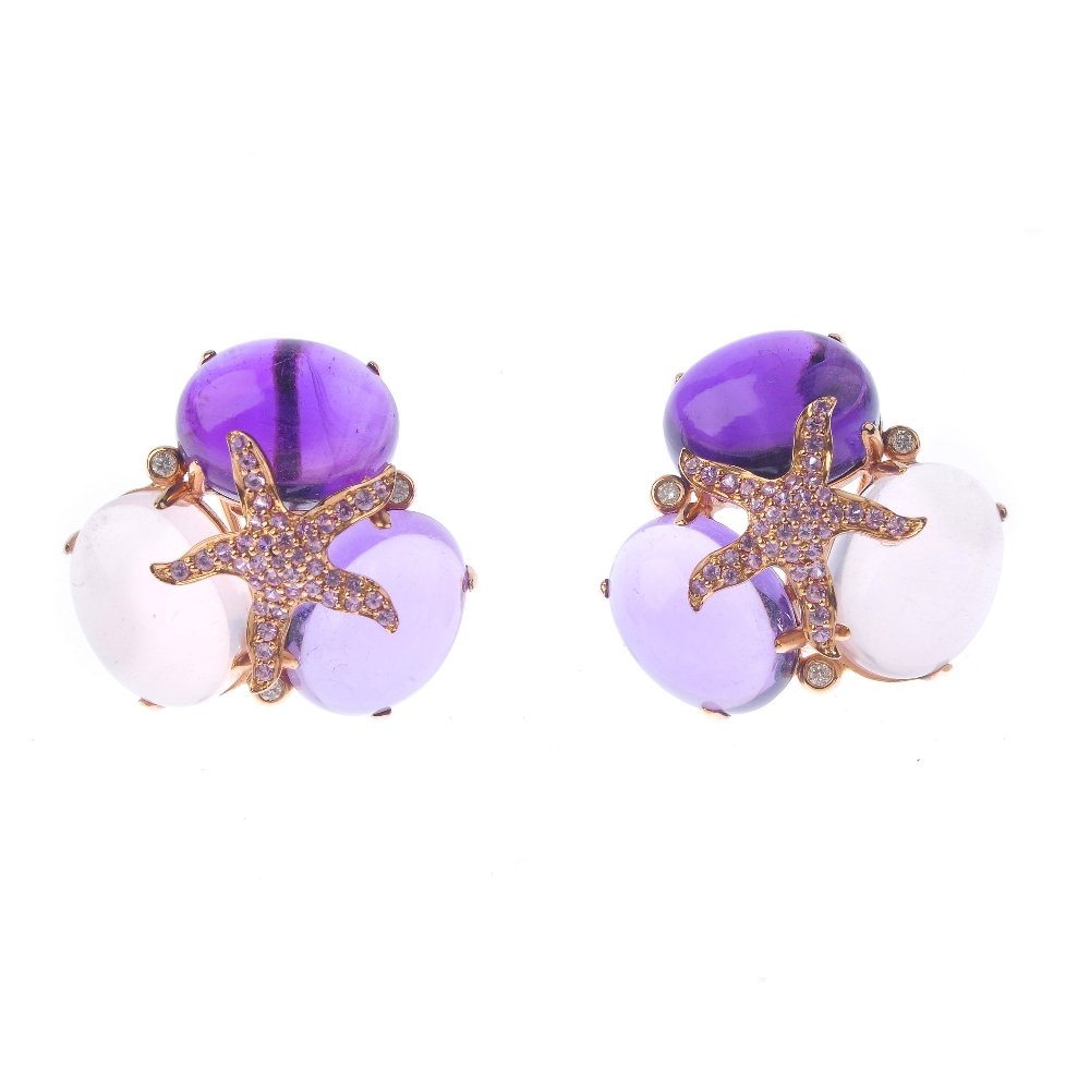 (131366-1-A) A pair of gem-set ear studs. Each designed (1 of 3)