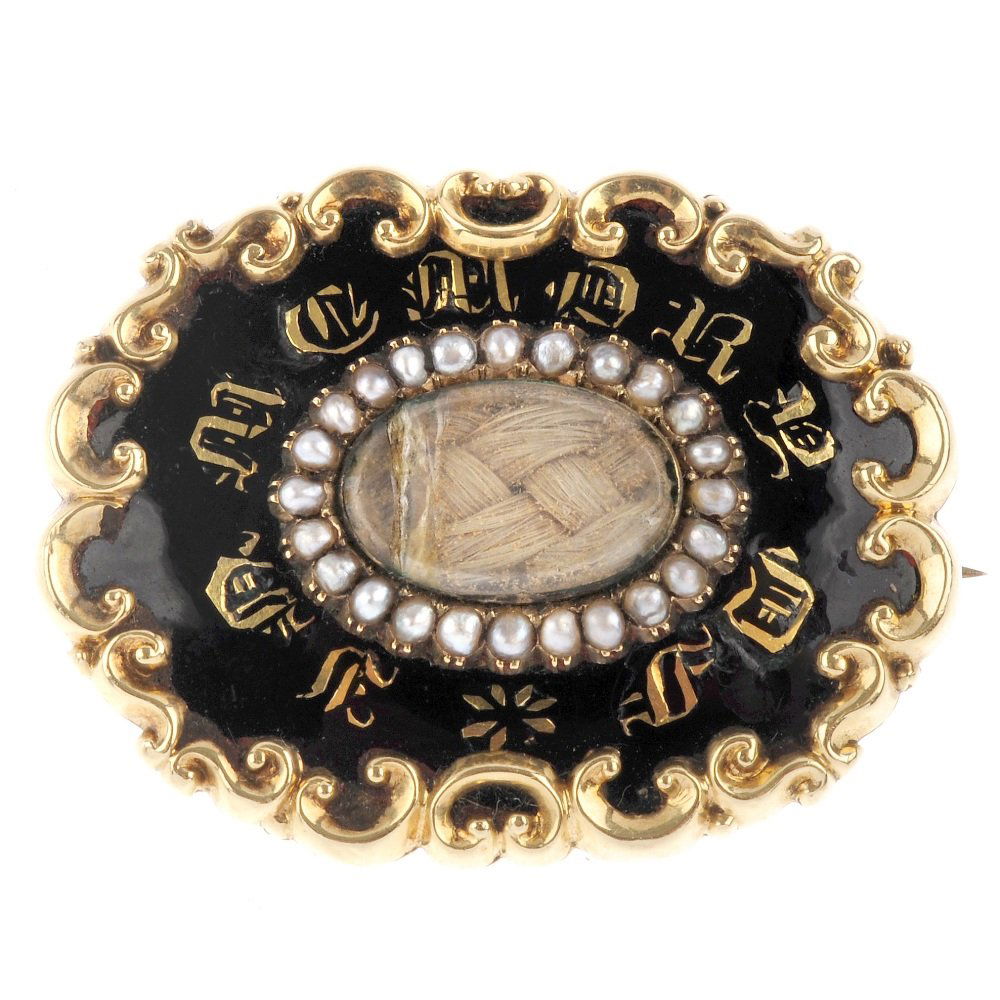 A mid Victorian enamel and split pearl mourning brooch. (1 of 2)