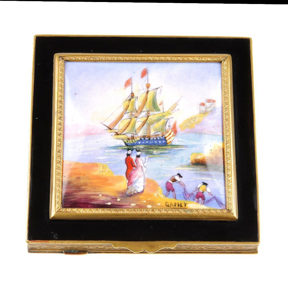 An enamel compact. The square shape compact with black: An enamel compact. The square shape compact with black enamel border to the central square enamel panel depicting a harbour scene with galleon sailing past, embossed edge and opening to a mirror withi