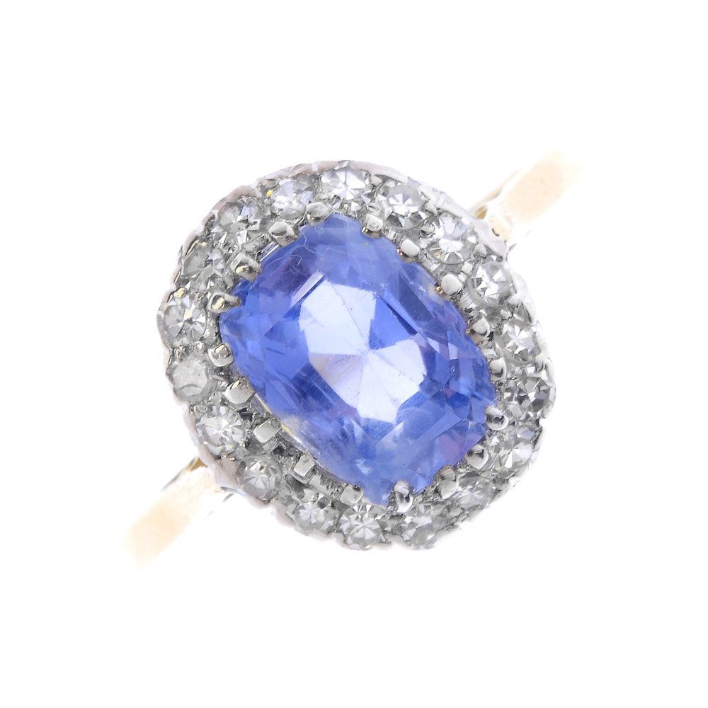 A Ceylon sapphire and diamond cluster ring. The (1 of 4)