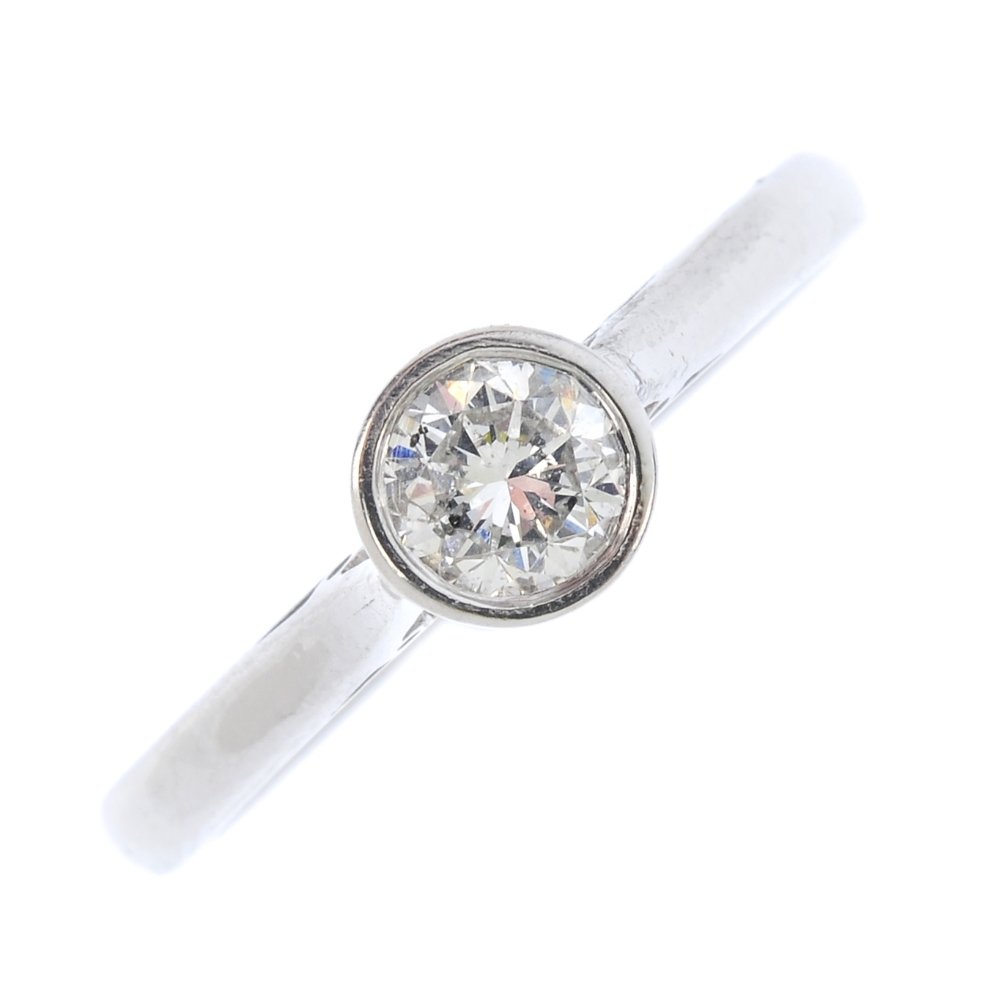 An 18ct gold diamond single-stone ring. The (1 of 3)