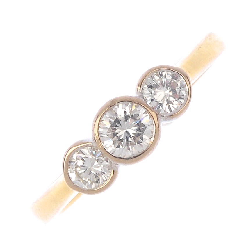 An 18ct gold diamond three-stone ring. The graduated (1 of 3)