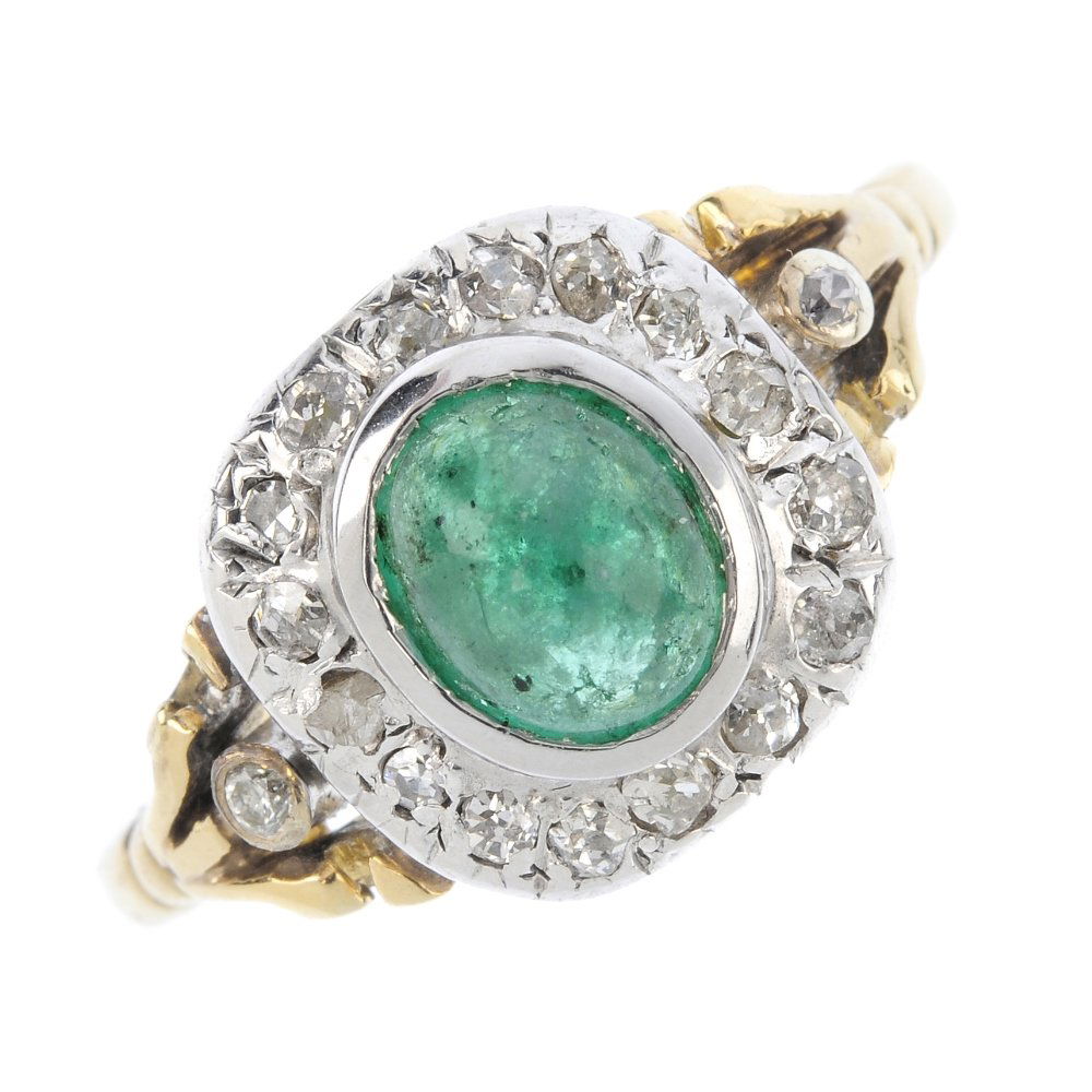 An emerald and diamond cluster ring. The oval emerald (1 of 3)