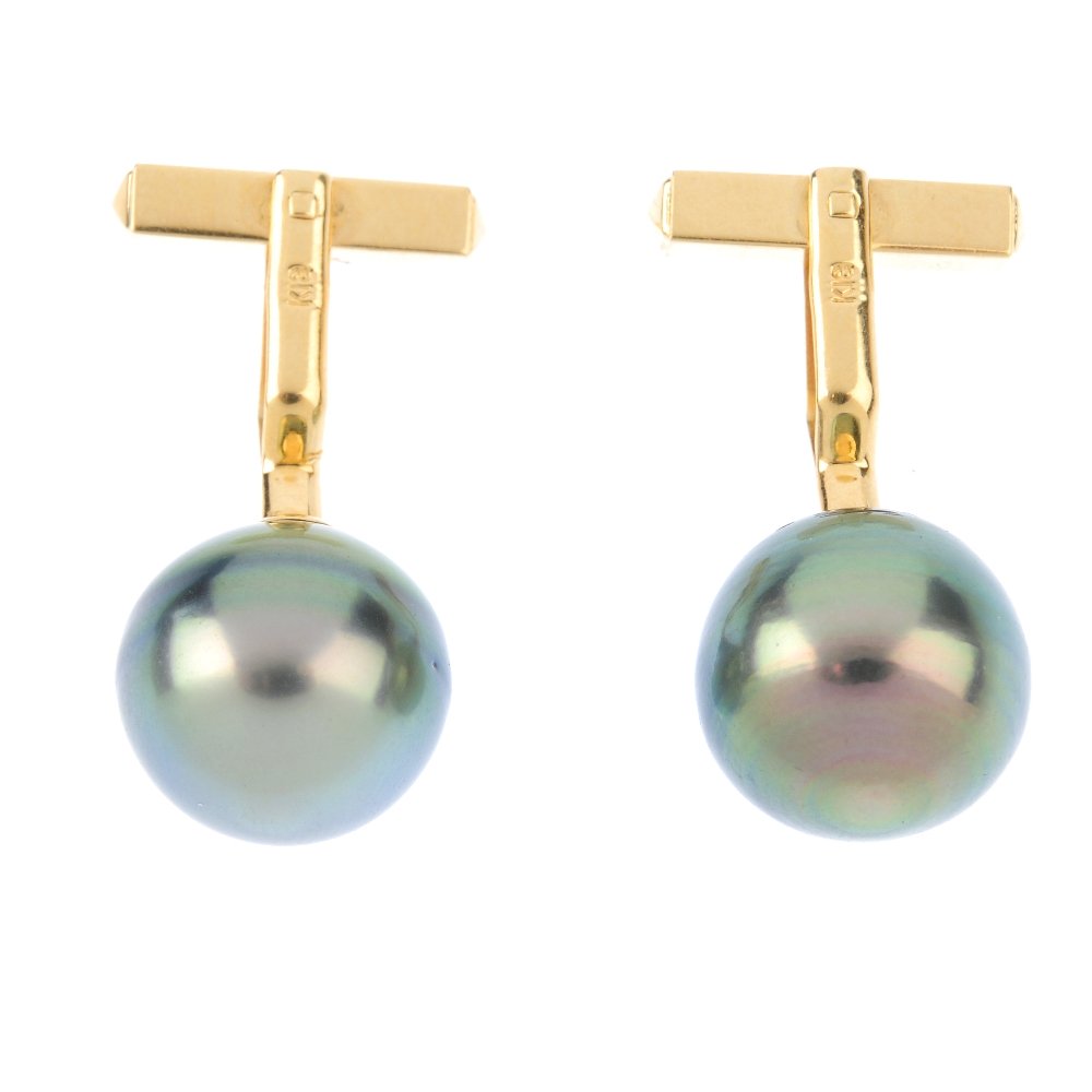 A pair of Tahitian cultured pearl cufflinks. Each: A pair of Tahitian cultured pearl cufflinks. Each designed as a Tahitian cultured pearl measuring 13.2 or 13.4mms, to the swivel bar back fittings. Weight 9.6gms.