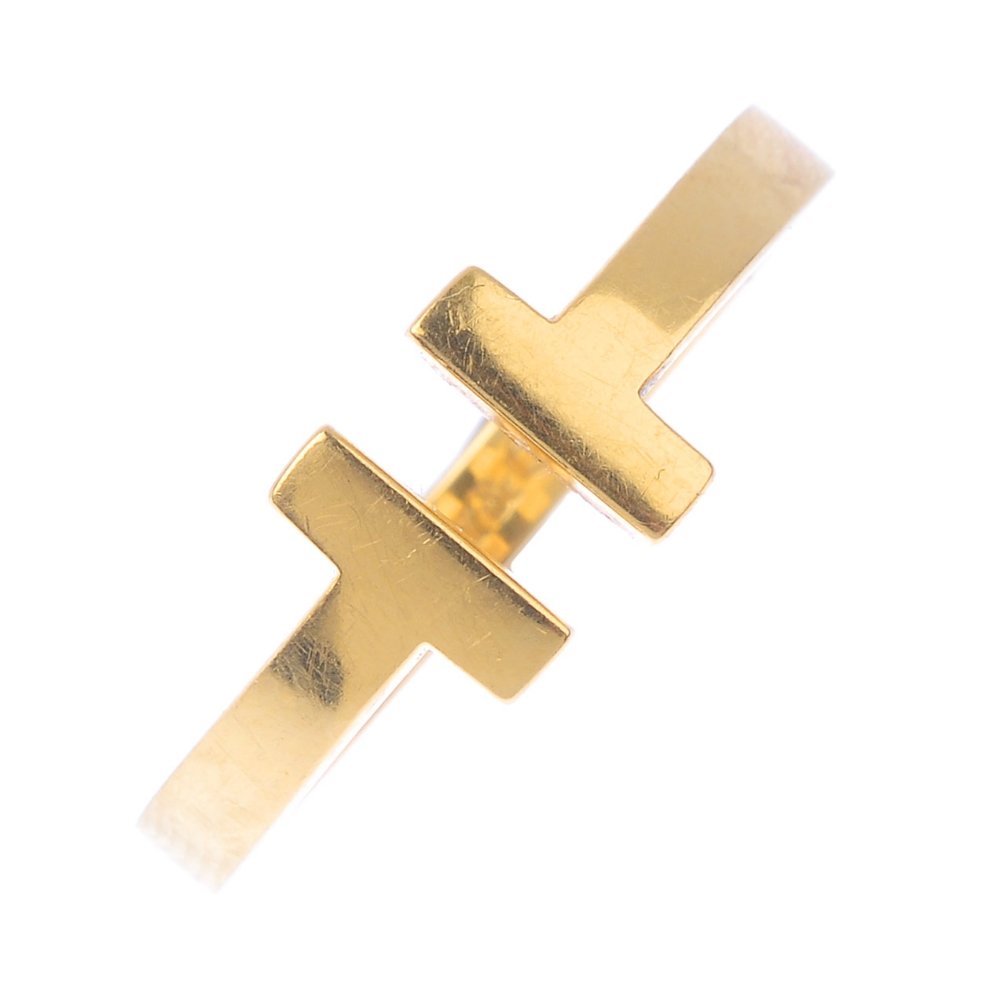 TIFFANY & CO - a 'T' ring. Of open design, with: TIFFANY & CO - a 'T' ring. Of open design, with stylised 'T' terminals. Signed Tiffany & Co. Ring size N. Weight 6.7gms.
