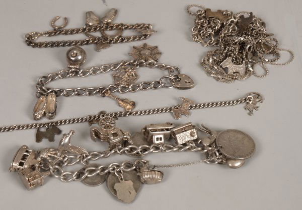 HM silver curb bracelet and padlock set with thirt: HM silver curb bracelet and padlock set with thirteen charms (including coins), three other white metal curb link bracelets with charms, and four white metal necklets. Weight 143gms.