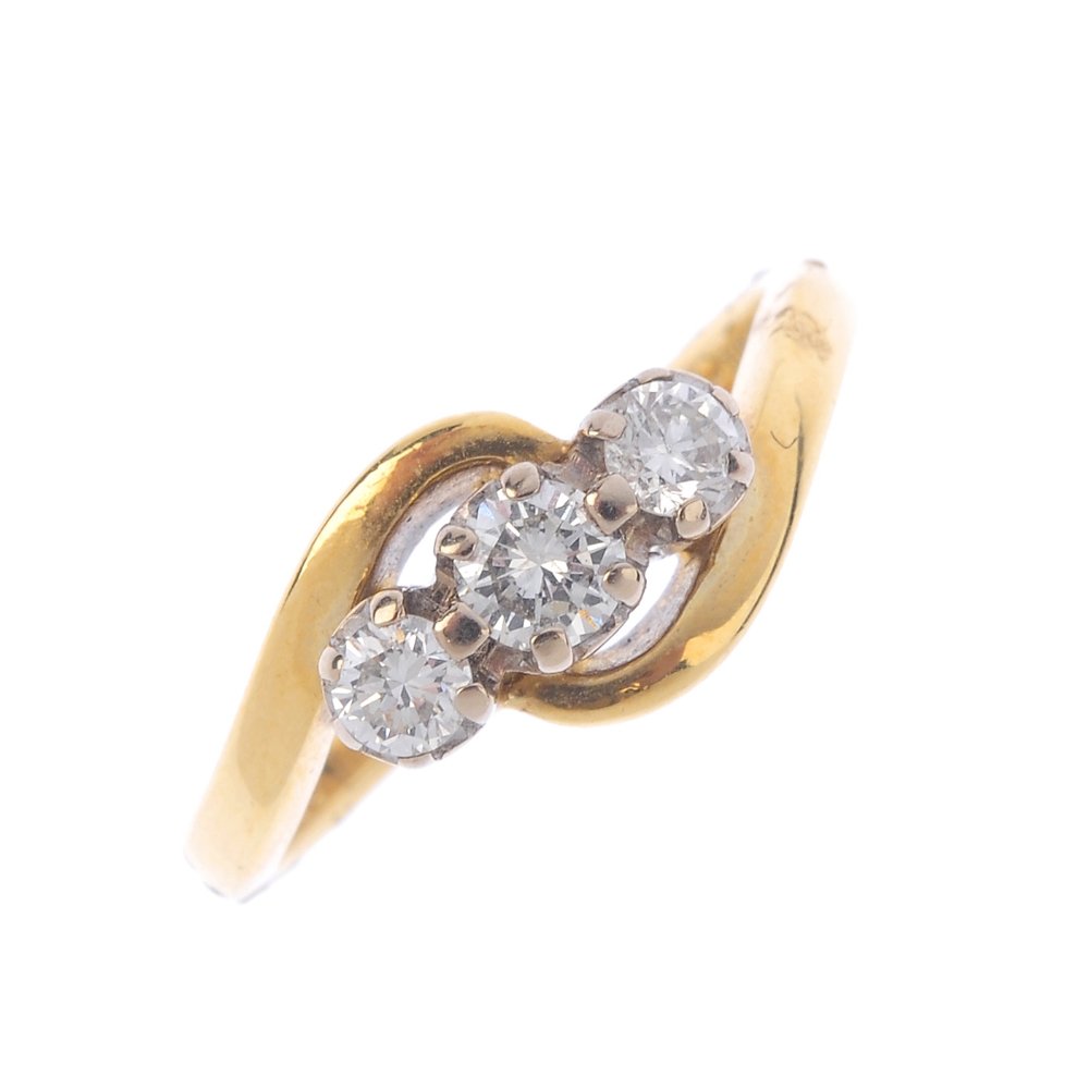 An 18ct gold diamond three-stone ring. The graduated (1 of 3)