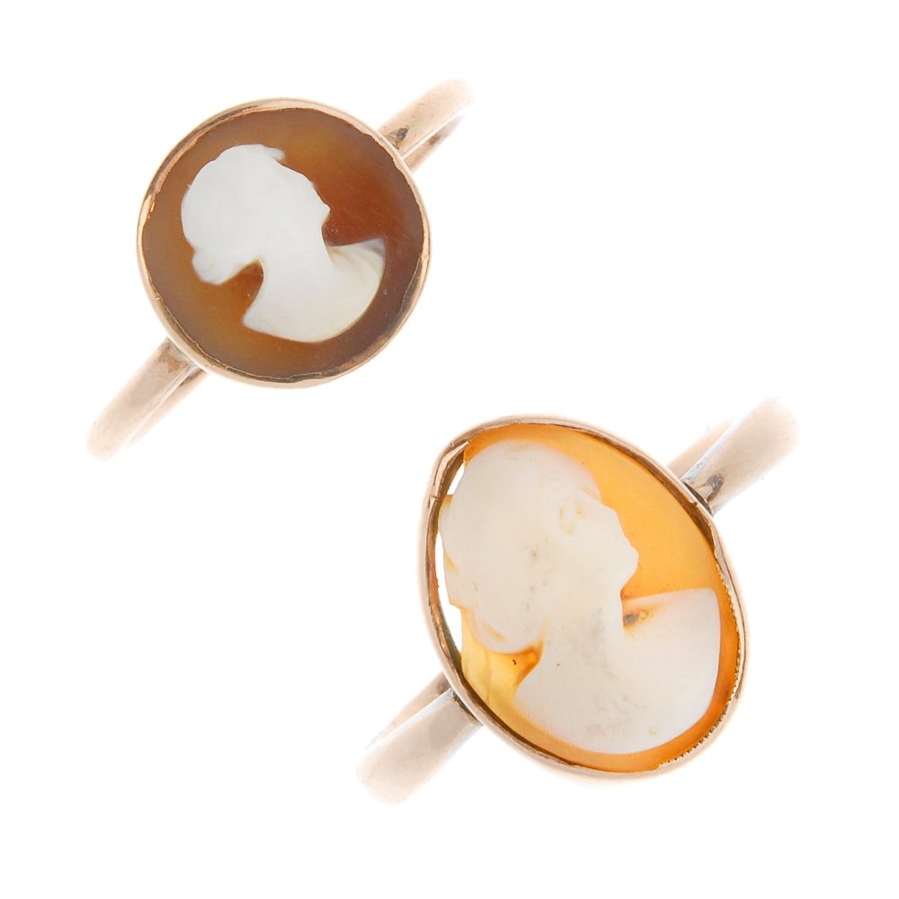 Two cameo rings. Designed as an oval or circular shell: Two cameo rings. Designed as an oval or circular shell cameo panel collet-set to the plain bands. Ring sizes O and P. Weight 5.3gms.
