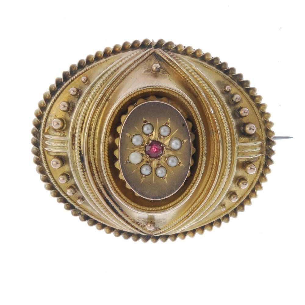 A memorial brooch. Of oval outline, central split pearl (1 of 2)