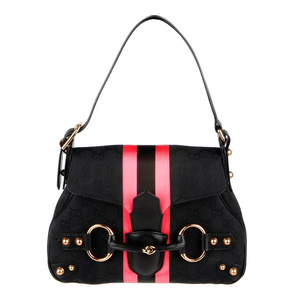 GUCCI by Tom Ford - a Horsebit handbag. Designed with: GUCCI by Tom Ford - a Horsebit handbag. Designed with maker's black monogram canvas exterior, smooth black leather trim and bronze-tone hardware accents, with a neon pink and black central satin strip