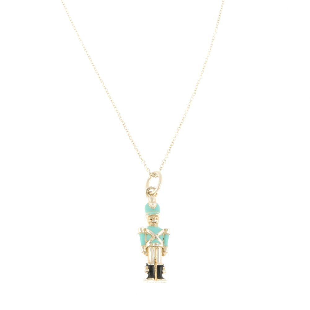TIFFANY & CO. - an enamel solider pendant. The pendant: TIFFANY & CO. - an enamel solider pendant. The pendant designed as a solider with green enamel hat and top and black enamel boots, suspended from a fine belcher-link chain to the spring-ring clasp. Si