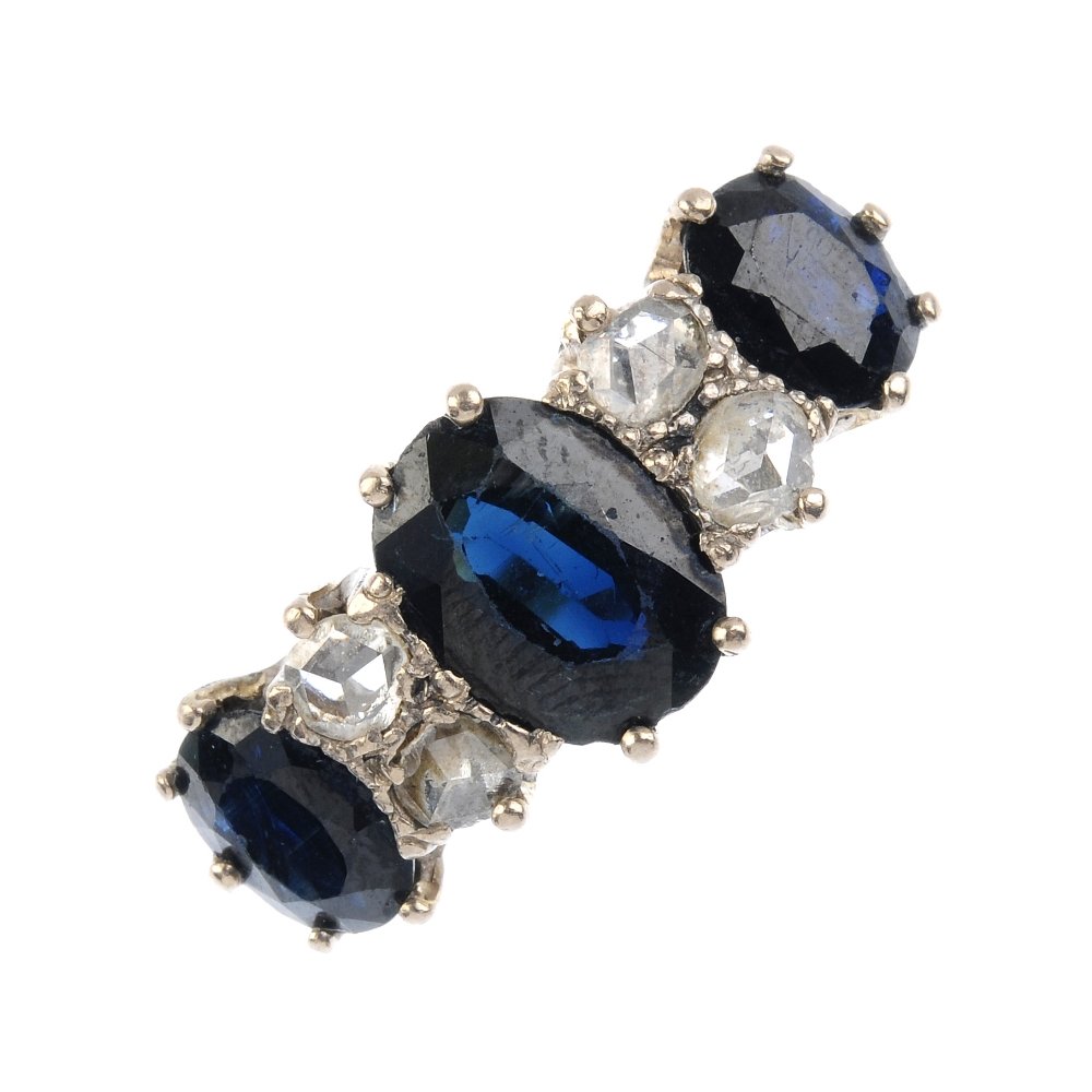 A sapphire and diamond dress ring. The graduated (1 of 3)