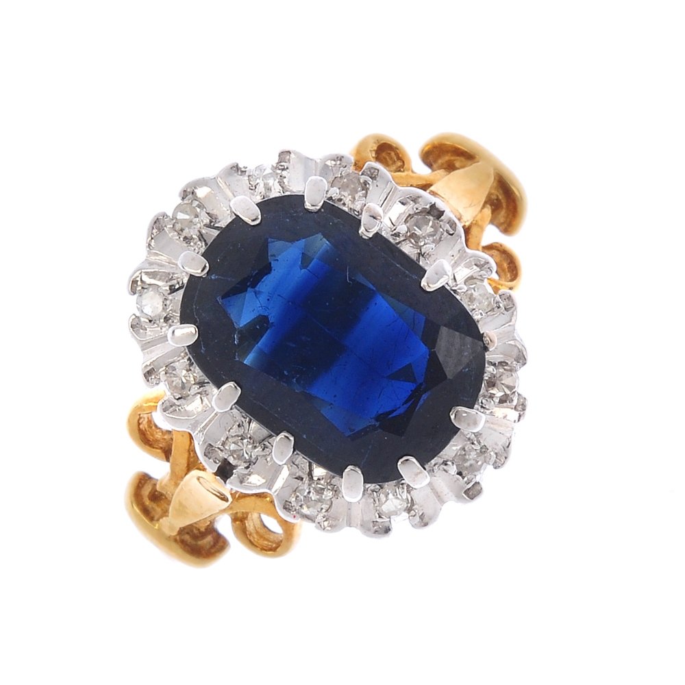 An 18ct gold sapphire and diamond cluster ring. The (1 of 3)