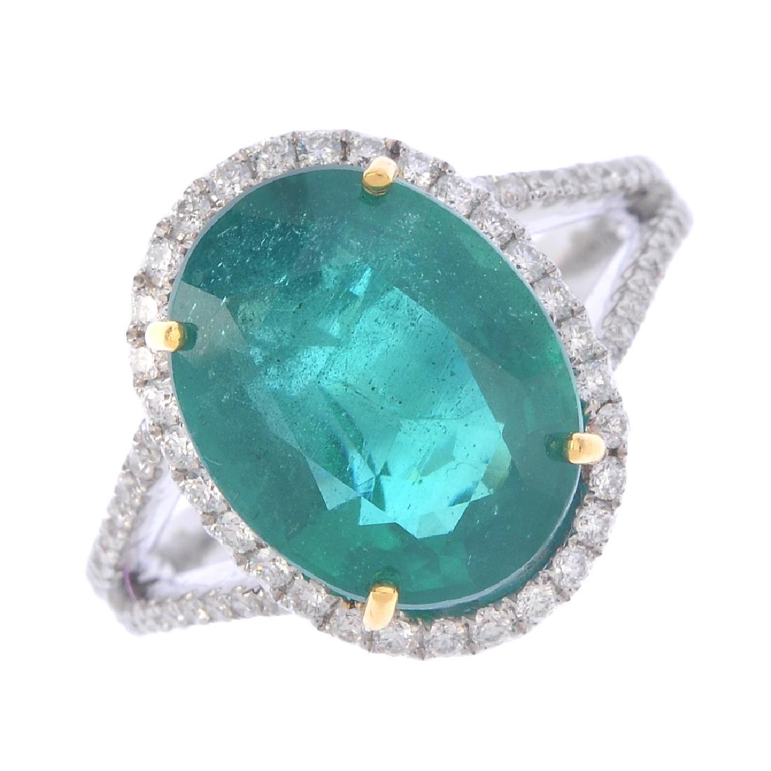 An emerald and diamond cluster ring. The oval-shape (1 of 3)