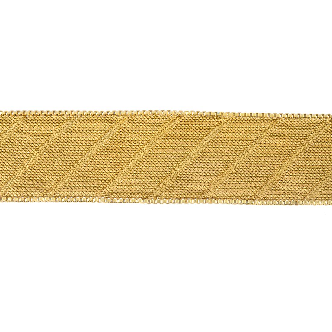 A 1960s 18ct gold bracelet. The textured panel, with (1 of 2)