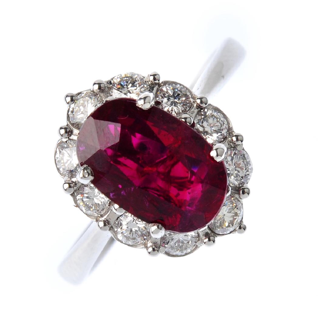 A ruby and diamond cluster ring. The oval-shape ruby, (1 of 4)