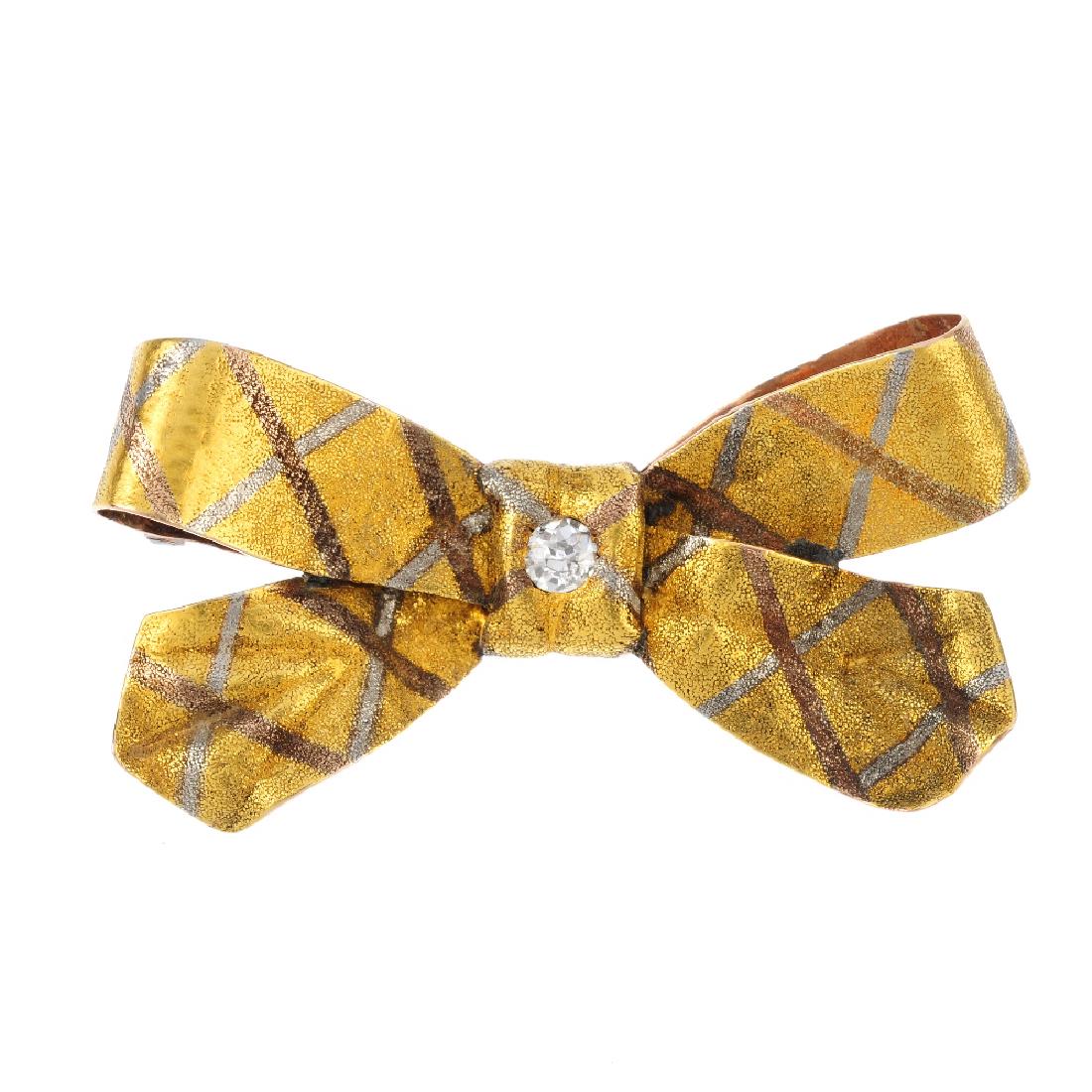 A late Victorian diamond bow brooch. The tri-colour (1 of 2)