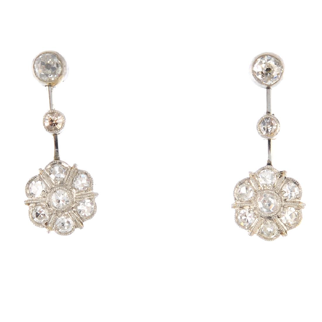 A pair of diamond earrings. Each designed as a (1 of 2)