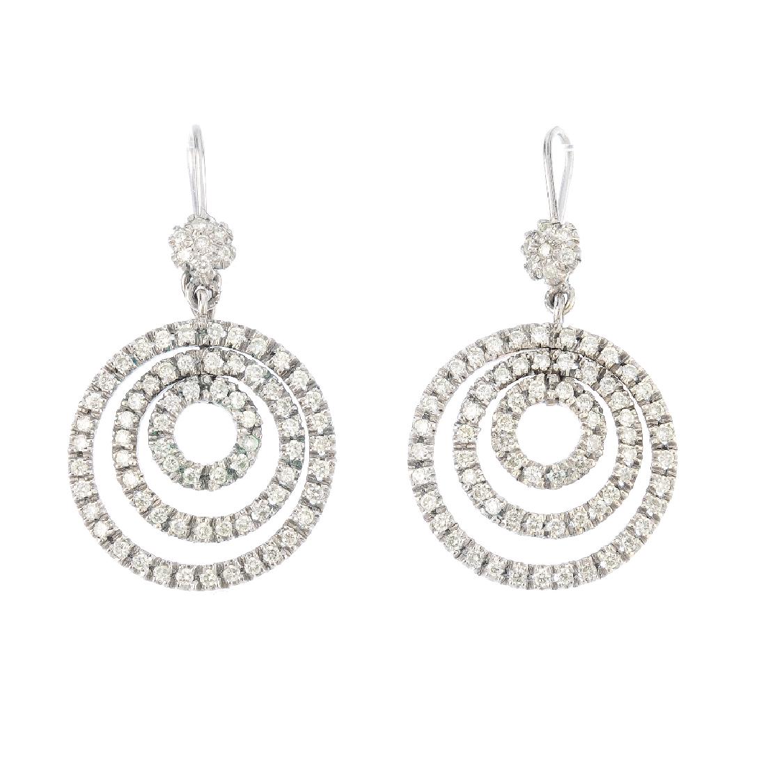 A pair of diamond earrings. Each designed as a series (1 of 2)