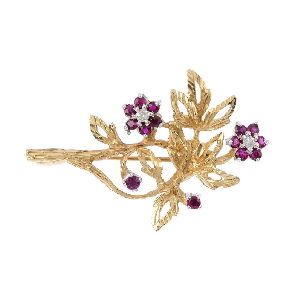 A diamond and ruby floral brooch. Of openwork design, (1 of 2)