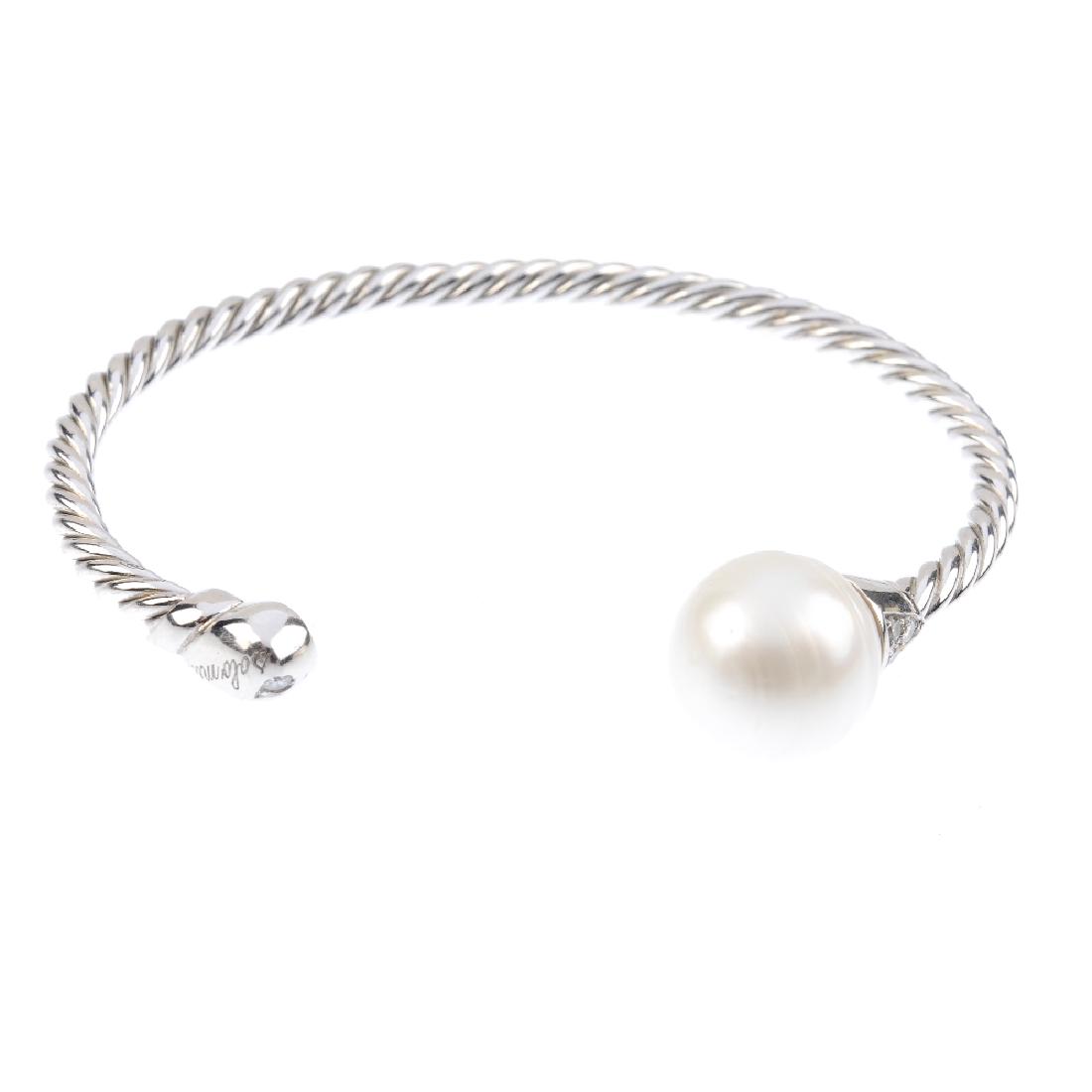 CHIMENTO - an 18ct gold cultured pearl and diamond: CHIMENTO - an 18ct gold cultured pearl and diamond bangle. The spiral cuff, with cultured pearl and brilliant-cut diamond trefoil terminals. Signed Chimento. Hallmarks for London, 2001. Inner diameter