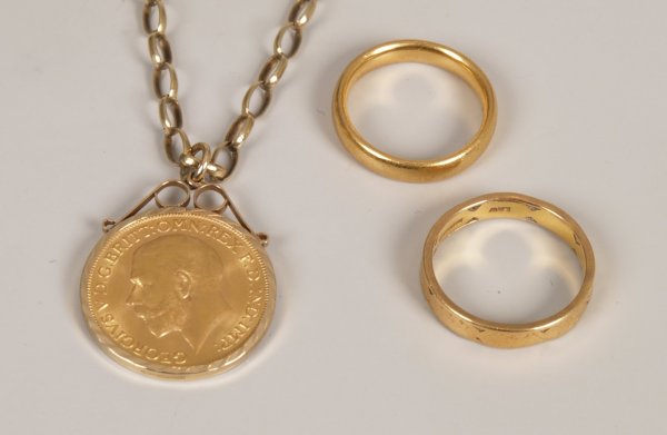 George V full sovereign mounted as a pendant in 9ct: George V full sovereign mounted as a pendant in 9ct gold with a similar belcher necklace (16gms) and two 22ct gold wedding rings (10gms).