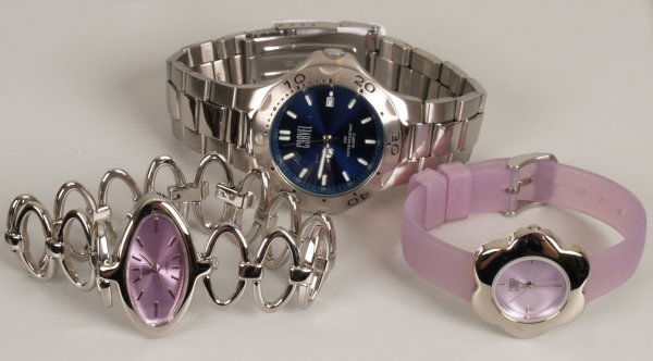 Twenty ladies steel cased Carvel watches with pur: Twenty ladies steel cased Carvel watches with purple dials and oval link bracelets; Twenty ladies steel cased Carvel watches with flower watch heads and fitted on purple straps; Ten gents steel cased
