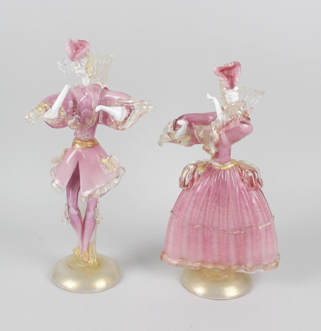 A pair of Murano pink and white mottled glass figures,: A pair of Murano pink and white mottled glass figures, modelled as a lady and dandy, with white glass heads and arms, and gilt speckled clear glass frills, trailed decoration and bases, largest 15.75 