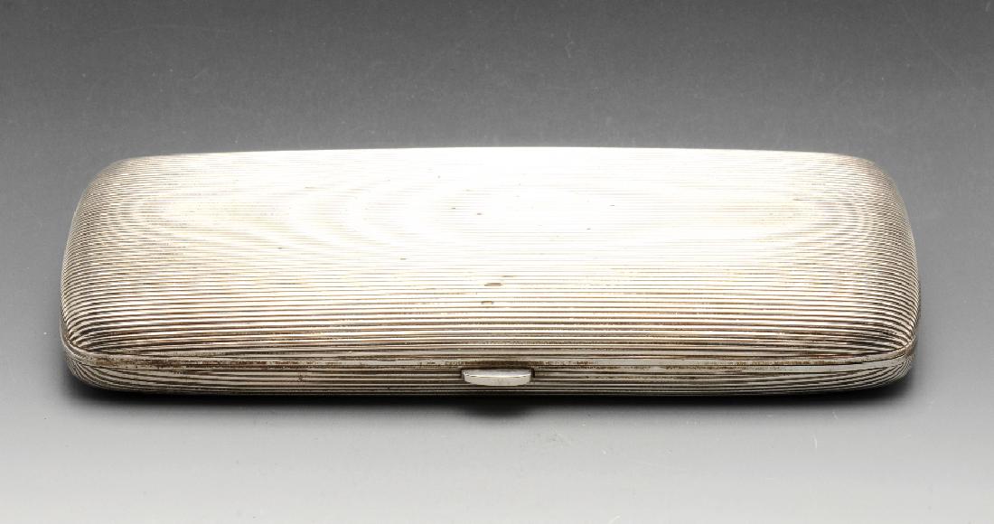 An early twentieth century Austro-Hungarian imported: An early twentieth century Austro-Hungarian imported silver cigar case of oblong form with reeded decoration and opening to a silver-gilt interior. Austro-Hungarian import mark (1901-1921). Length mea