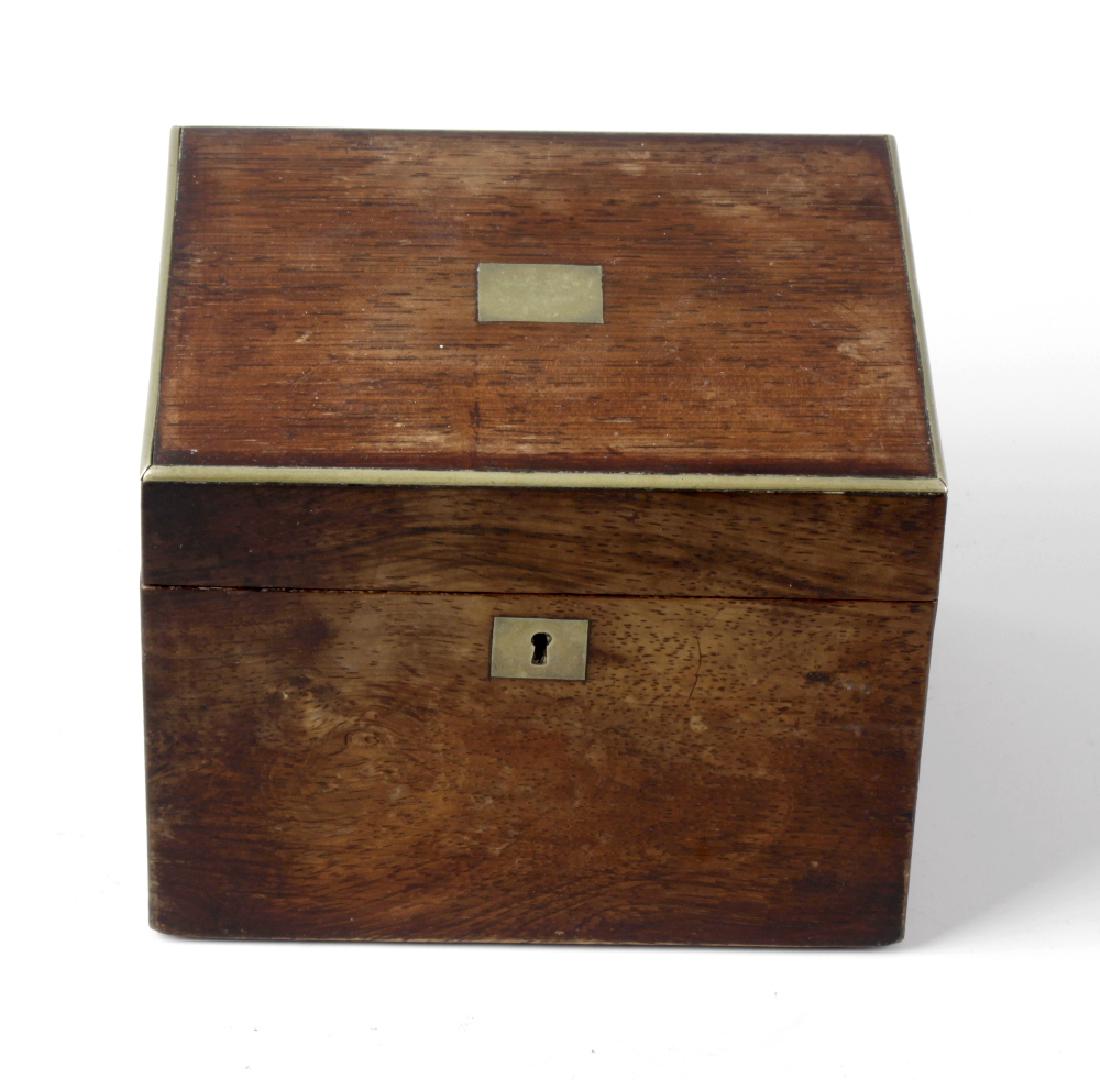 A 19th century rosewood veneered tea caddy of: A 19th century rosewood veneered tea caddy of rectangular form, the hinged brass edged opening top inset with a central brass panel above a front with conforming escutcheon plate, 5.5 x 4.25 (14cm x 1