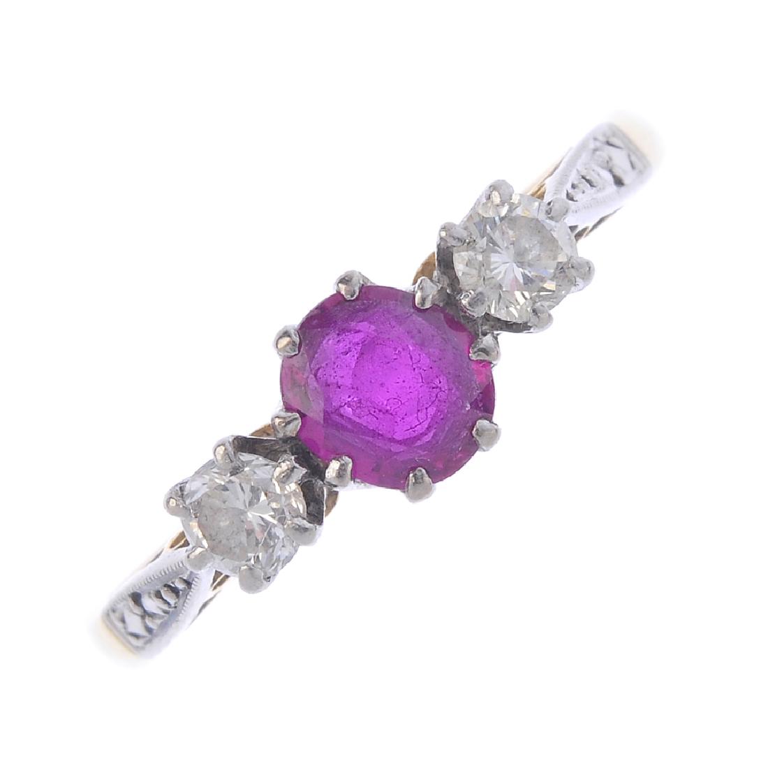 An 18ct gold ruby and diamond three-stone ring. The (1 of 3)