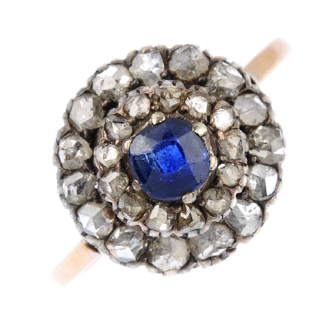 A sapphire and diamond cluster ring. The cushion-shape (1 of 3)