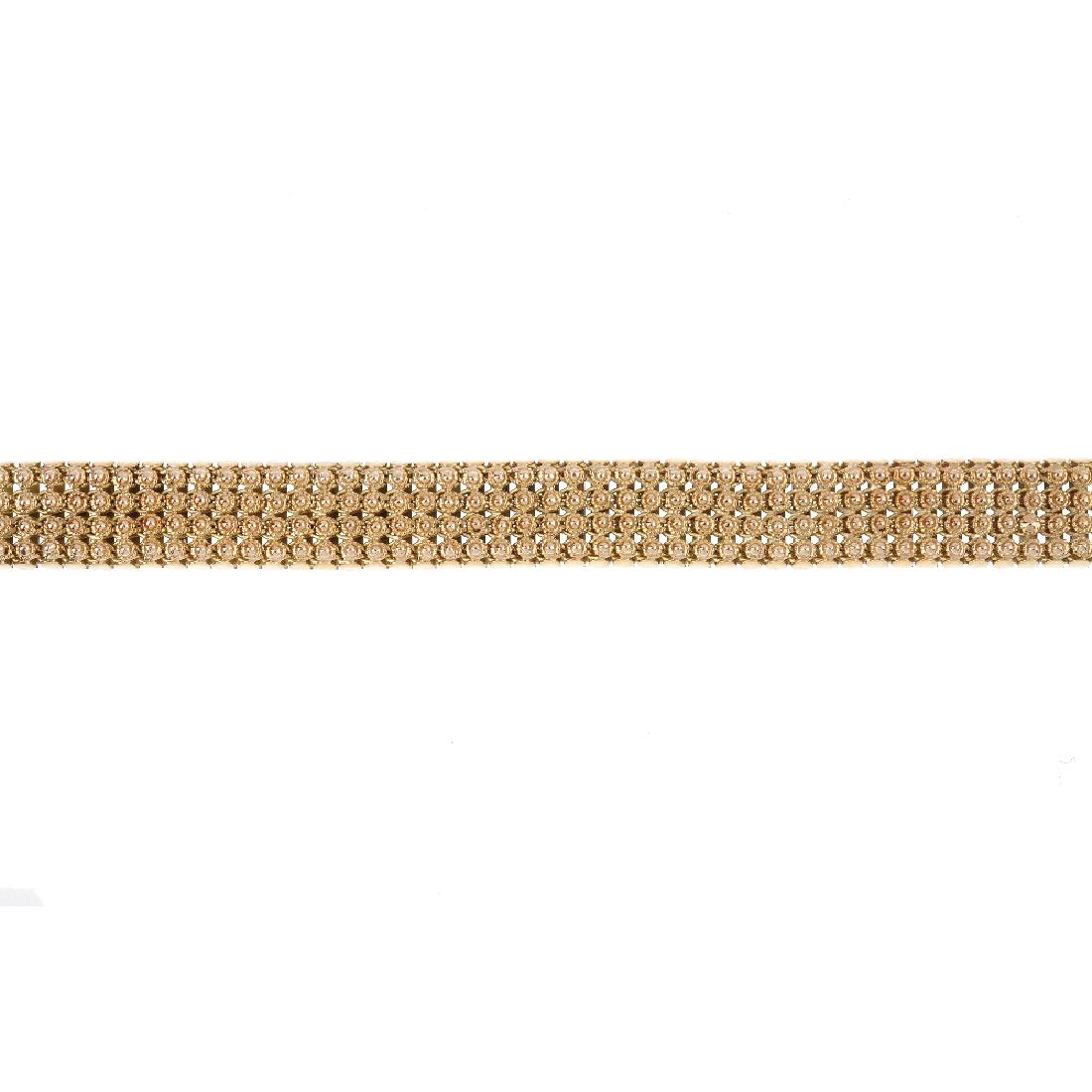 A 1960s 9ct gold bracelet. The fancy-link chain, with (1 of 2)