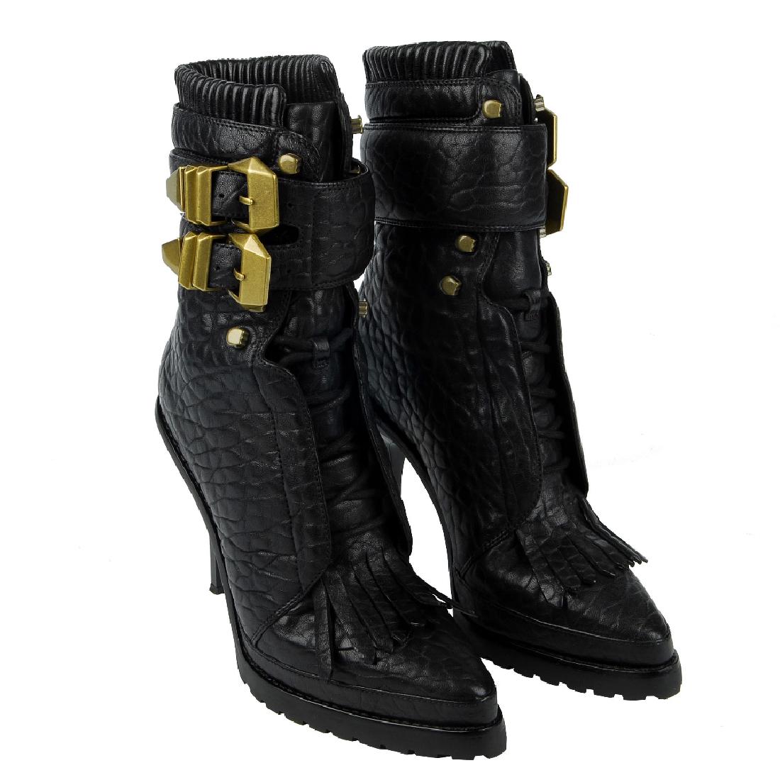 ALEXANDER WANG - a pair of Lara combat boots. Crafted: ALEXANDER WANG - a pair of Lara combat boots. Crafted from grained black leather and gold-tone hardware, designed with a pointed toe and stiletto heel, fringe detail to the front, concealed lace-up cl