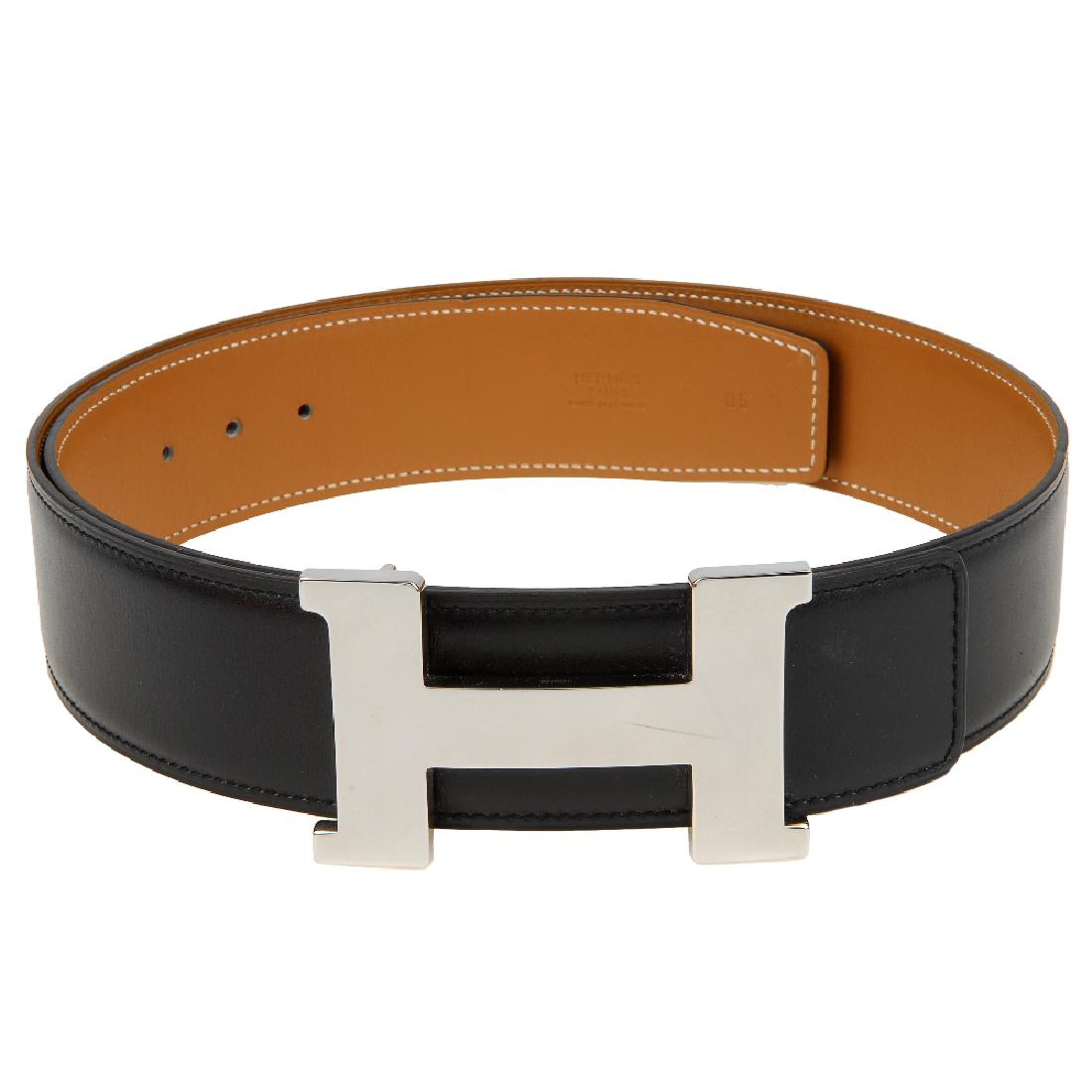 HERMÈS - a Constance H buckle and two leather belts. To: HERMÈS - a Constance H buckle and two leather belts. To include a polished silver-tone 'H' buckle with two reversible leather belts, one smooth brown and black example and one textured white and blue
