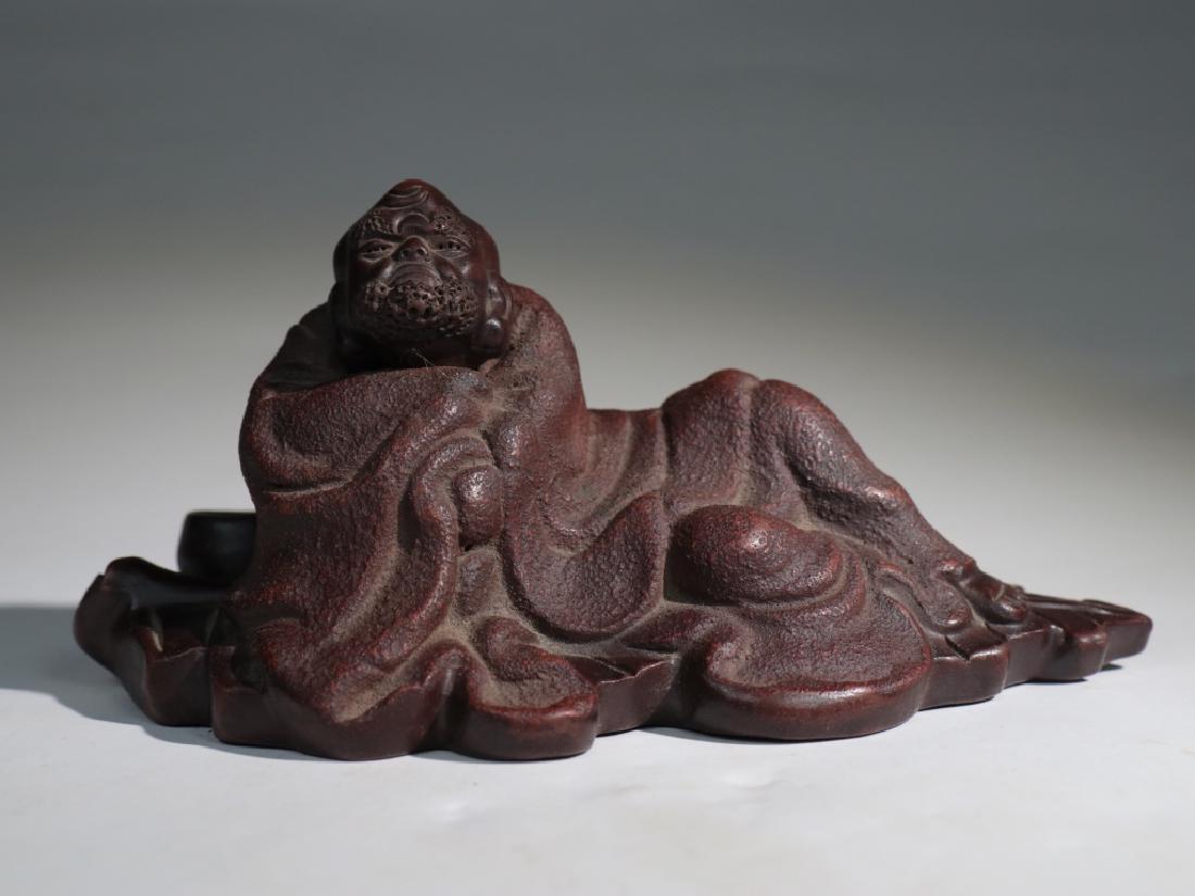 A YIXING PURPLE DHARMA INCENSE HOLDER: A yixing purple dharma incense holder:Length 12.8cm Width 6.1cm Height:6.4cm Weight:212.6g