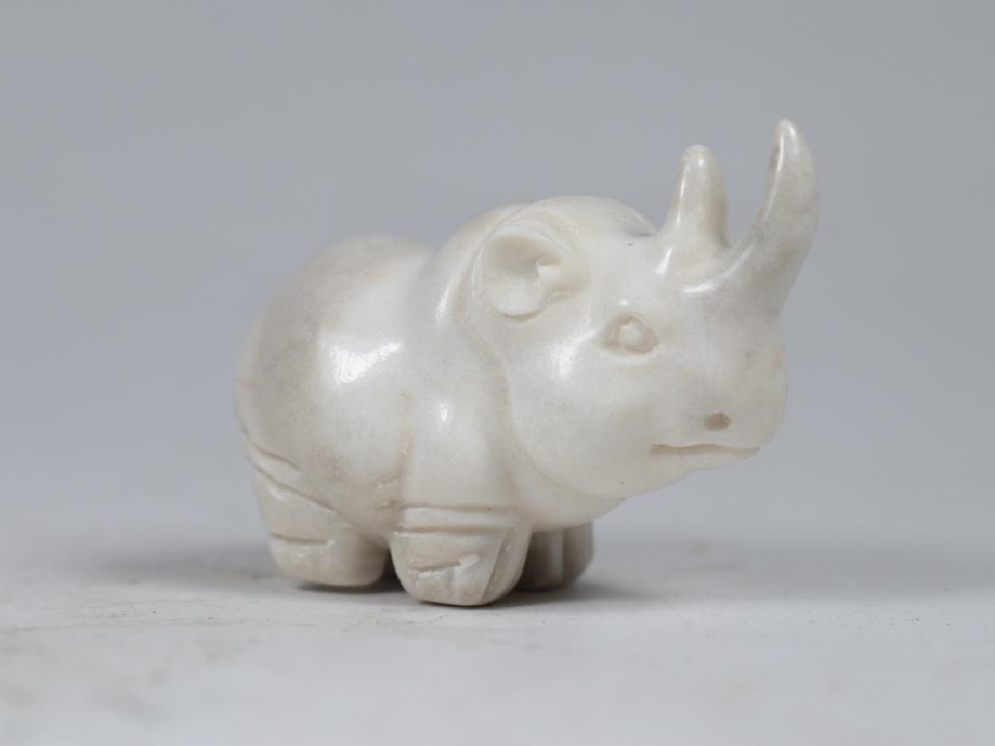 an ox horn carving rhinoceros statue: an ox horn carving rhinoceros statue: length-4.5cm width-2.2cm heigth-2.6cm weight-21.3g