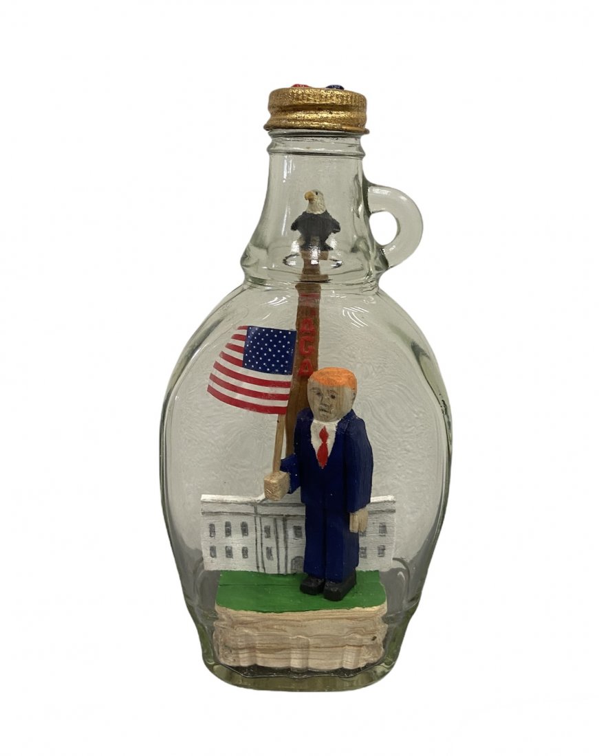 TIM RAY FISHER (b. 1969, Indiana) Donald Trump: Very unique bottle assemblage 7 inches high x 3 in x 1 1/2 in. Tim Ray Fisher was born on November 7, 1969, in Goshen, Indiana. He survived a traumatic childhood, which would later lead to PTSD and Ma