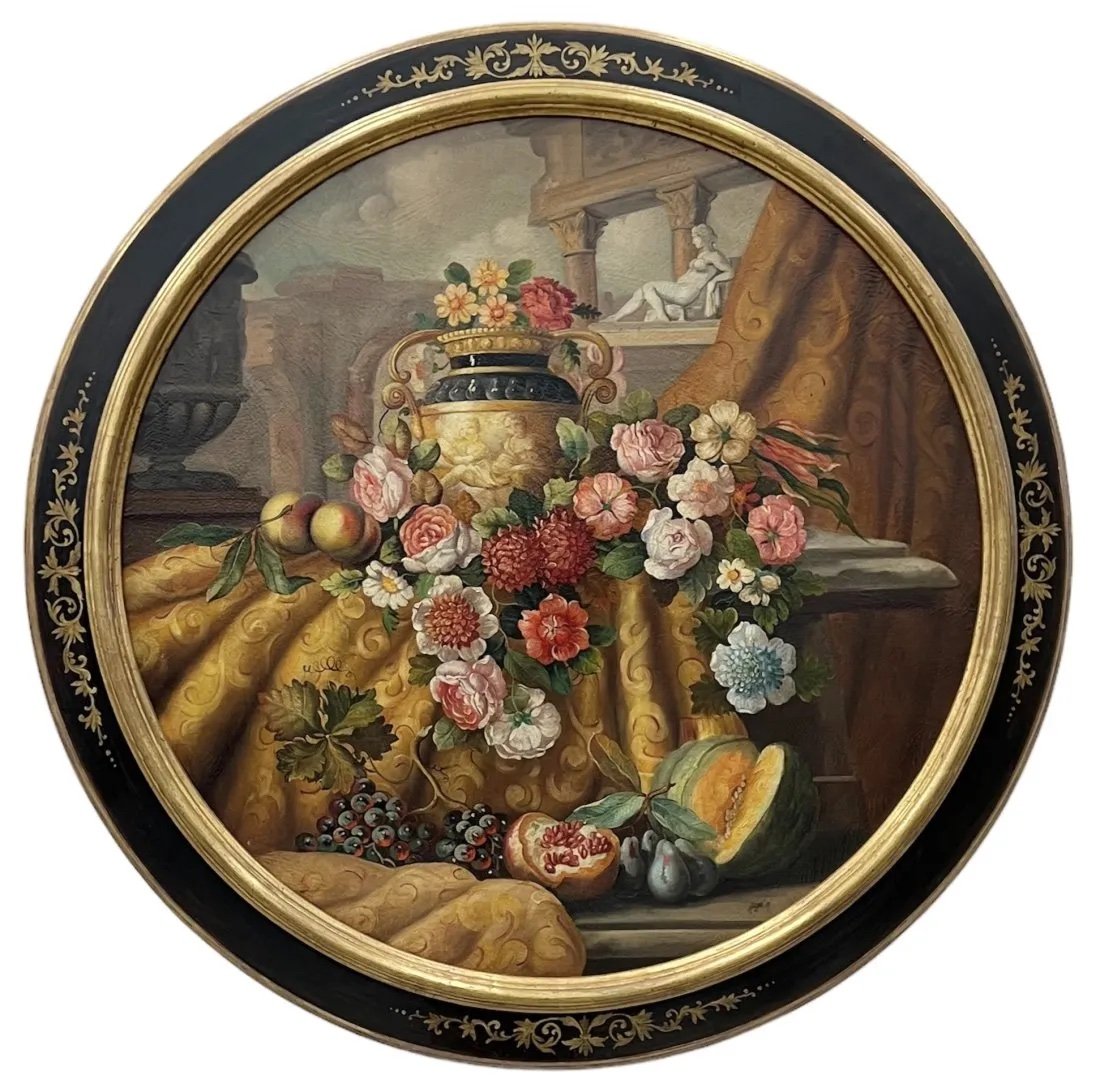 Large Round Colorful Italian Mid-19th Century Architectural Capriccio w/ Flowers Still Life: Oil on canvas 48 D in (framed). Flowers and fruits. Reclining Venus or Cleopatra, cherubs, with an archway and colonade in the background. Stenciled wood and gilt frame