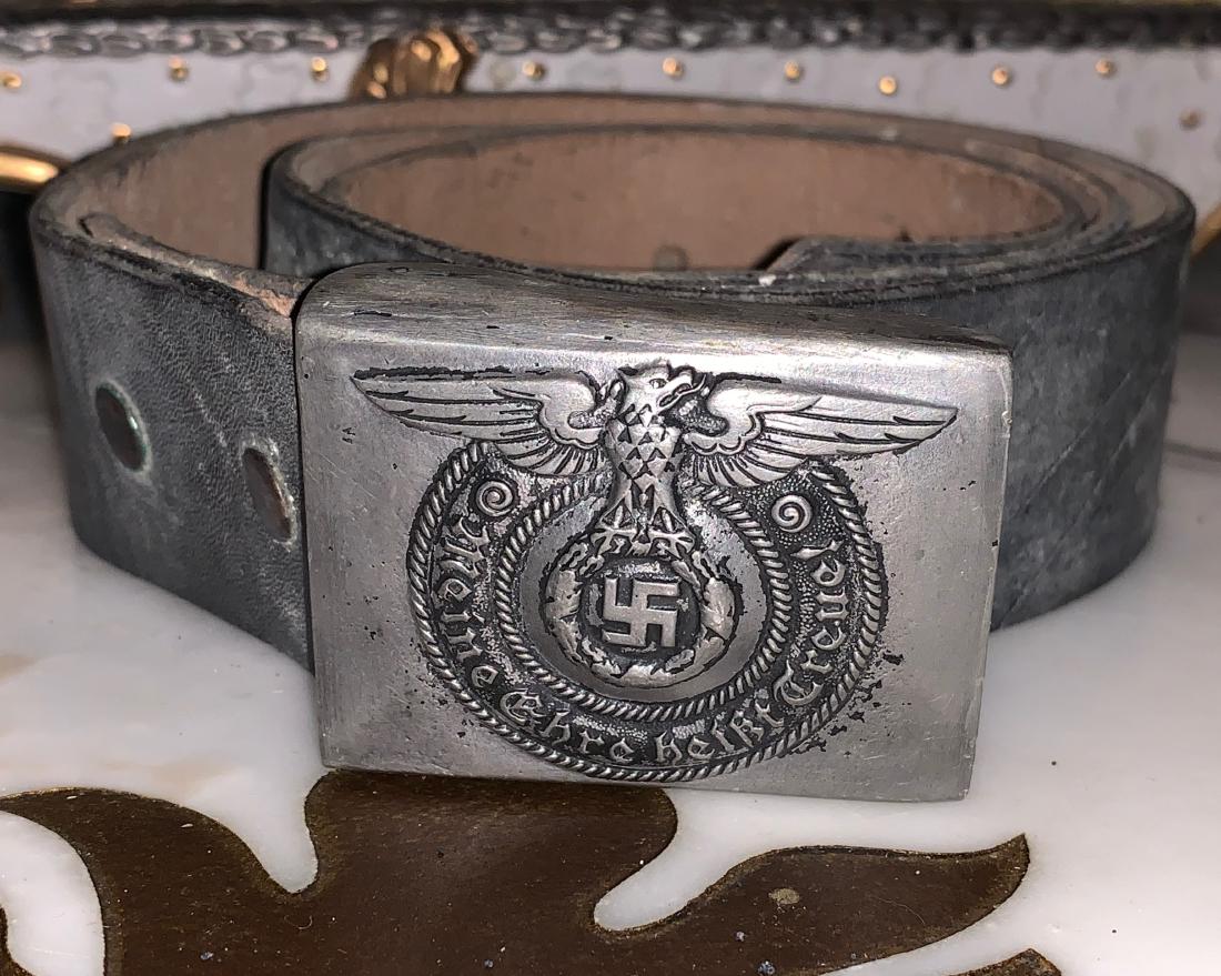 RARE WW2 GERMAN NAZI SS BELT BUCKLE WITH BELT: RARE WW2 GERMAN NAZI SS BELT BUCKLE WITH BELT. IN EXCELLENT SHAPE AND OVERALL CONDITION. BEAUTIFUL OVERALL PATINA. COMES FROM A WW2 VETERANS COLLECTION. A GREAT ADDITION TO YOUR COLLECTION.