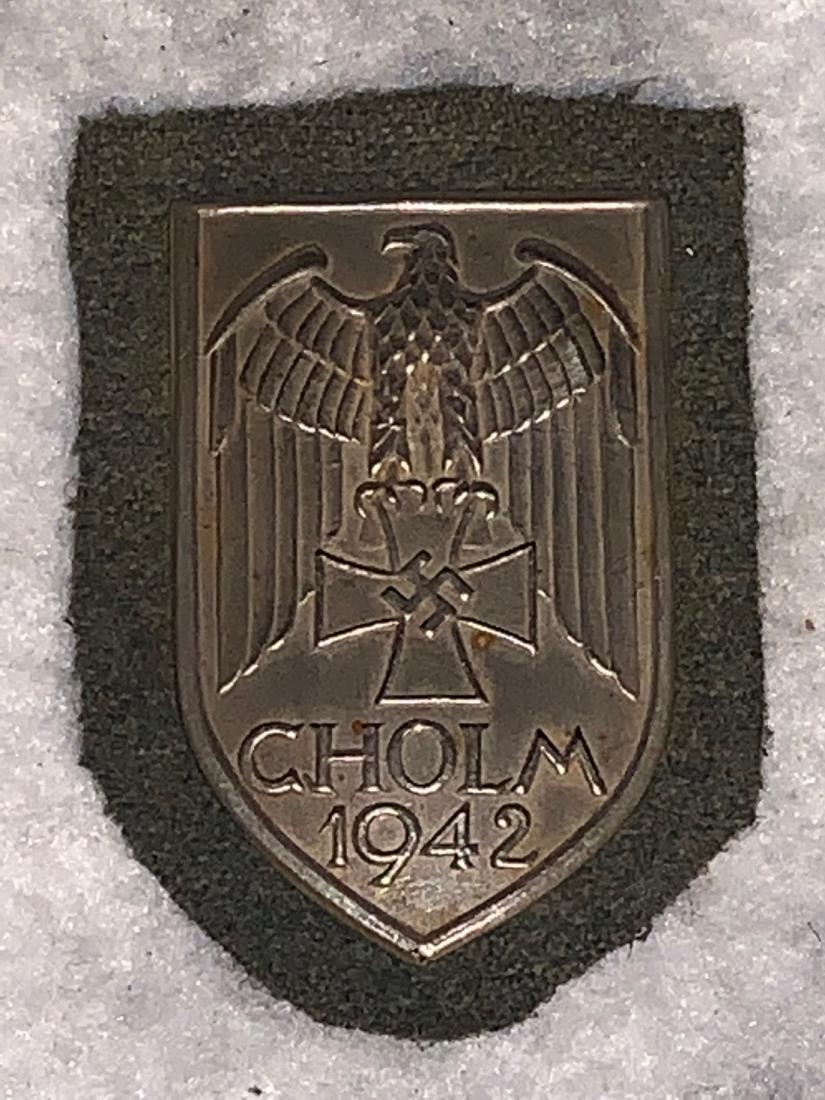 GERMAN WW2 3RD REICH CHOLM SHIELD 1942: GERMAN WW2 3RD REICH CHOLM SHIELD 1942. IN EXCELLENT SHAPE AND OVERALL CONDITION WITH A GREAT OVERALL PATINA. A GREAT FIND AND AN EXCELLENT ADDITION TO YOUR COLLECTION.