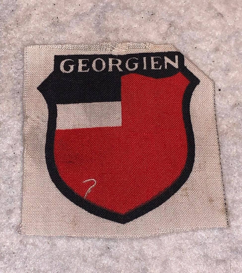 GERMAN WW2 SOVIET GEORGIA SS VOLUNTEER PATCH: GERMAN WW2 SOVIET GEORGIA SS VOLUNTEER PATCH. GUARANTEED 100% AUTHENTIC. This patch, outlined in black for the SS, was for Soviet Georgian Volunteers who wished to volunteer to fight against the Sovie