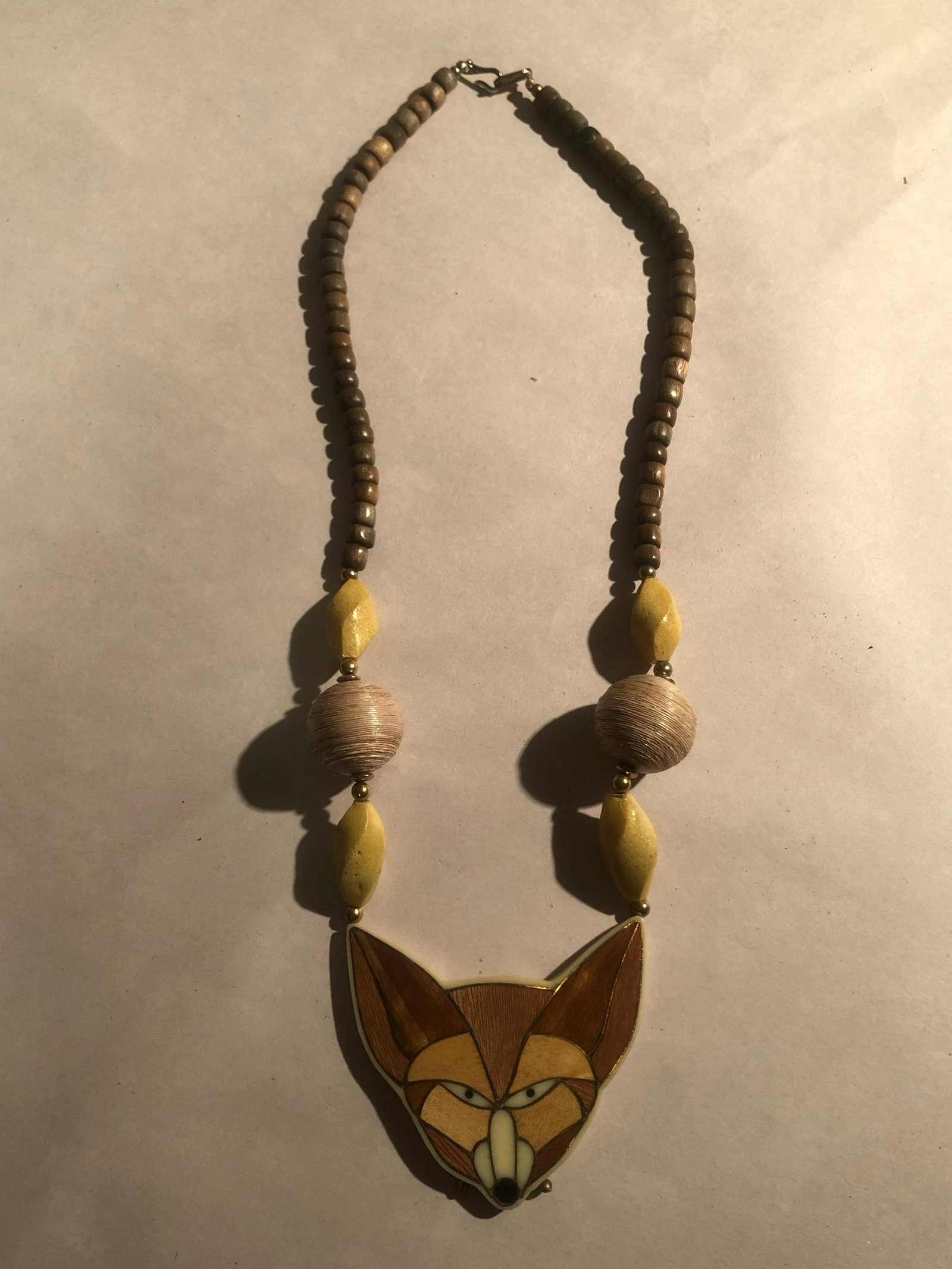 VINTAGE HAND-MADE LADIES NECKLACE: LADIES STERLING SILVER WEDDING RING. MADE OUT OF WOOD LIKE MATERIAL. A GREAT ADDITION TO YOUR COLLECTION.