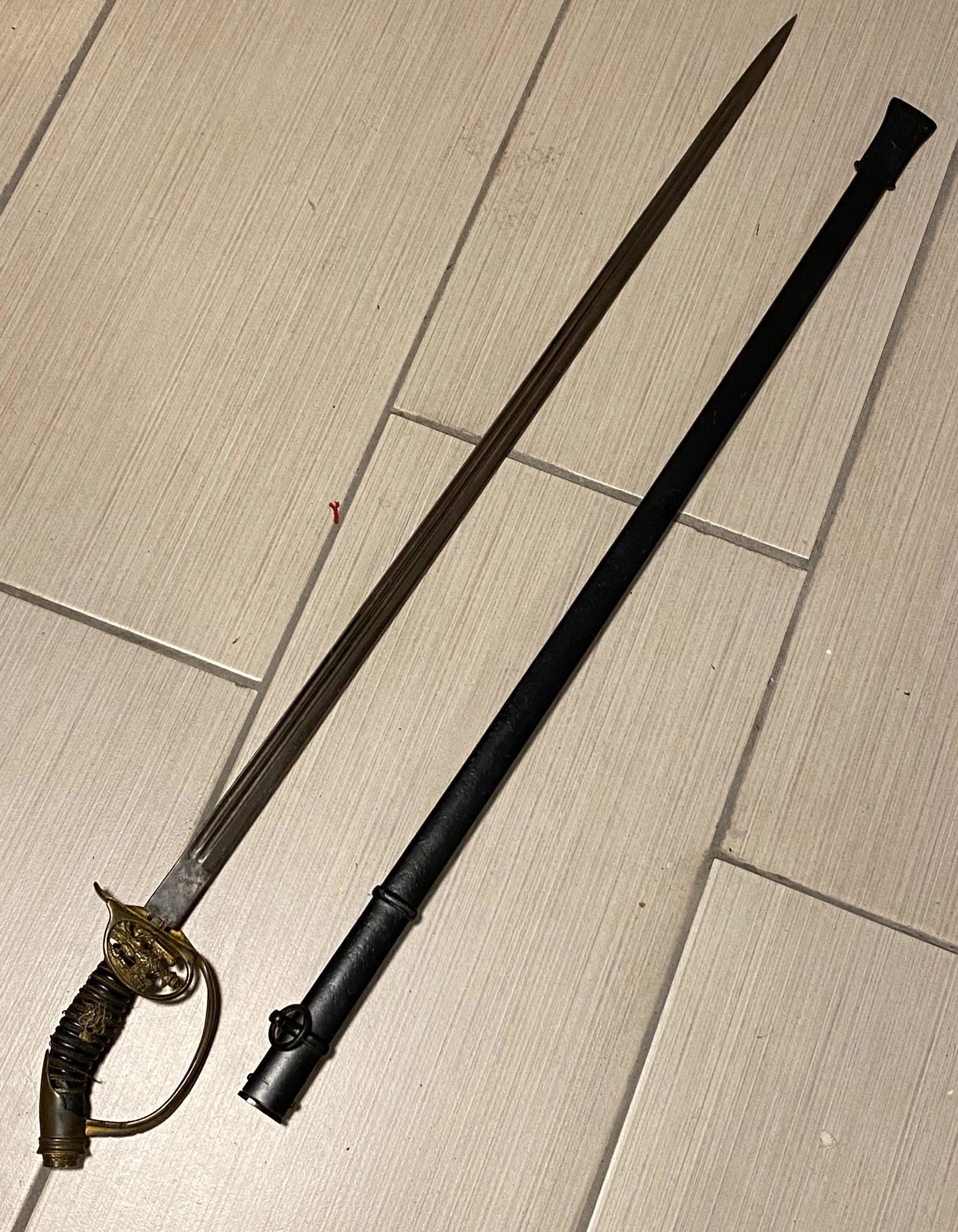 WW1 GERMAN OFFICERS SWORD - CARL EICKHORN: WW1 GERMAN OFFICERS SWORD - CARL EICKHORN. GERMAN KAISER WILHELM II SHIELD AND MARKINGS MARKED "CE" CARL EICKHORN WITH DOUBLE SQUIRREL BACK TO BACK APPROXIMATE 33" LONG STRAIGHT BLADE WITH SHEATH OVER