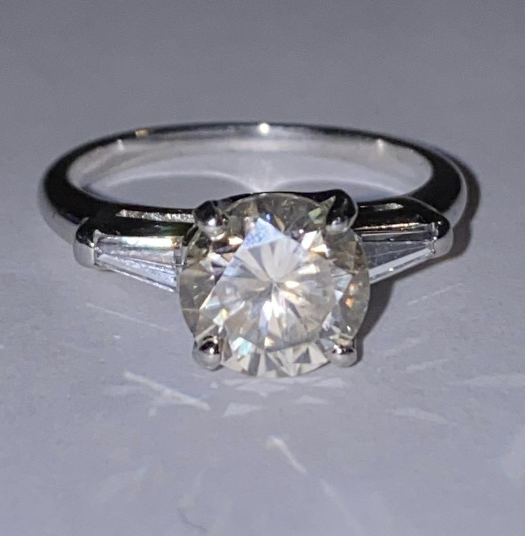 1.80 CT ROUND VS2, H DIAMOND PLATINUM WEDDING RING: 1.80 CT ROUND VS2, H DIAMOND PLATINUM WEDDING RING. THIS RING CONTAINS A LARGE MAN-MADE DIAMOND THAT IS TOP QUALITY AND CLARITY. IT TESTS AS A DIAMOND ON ANY DIAMOND TESTER BUT IT IS A MAN-MADE DIAMON