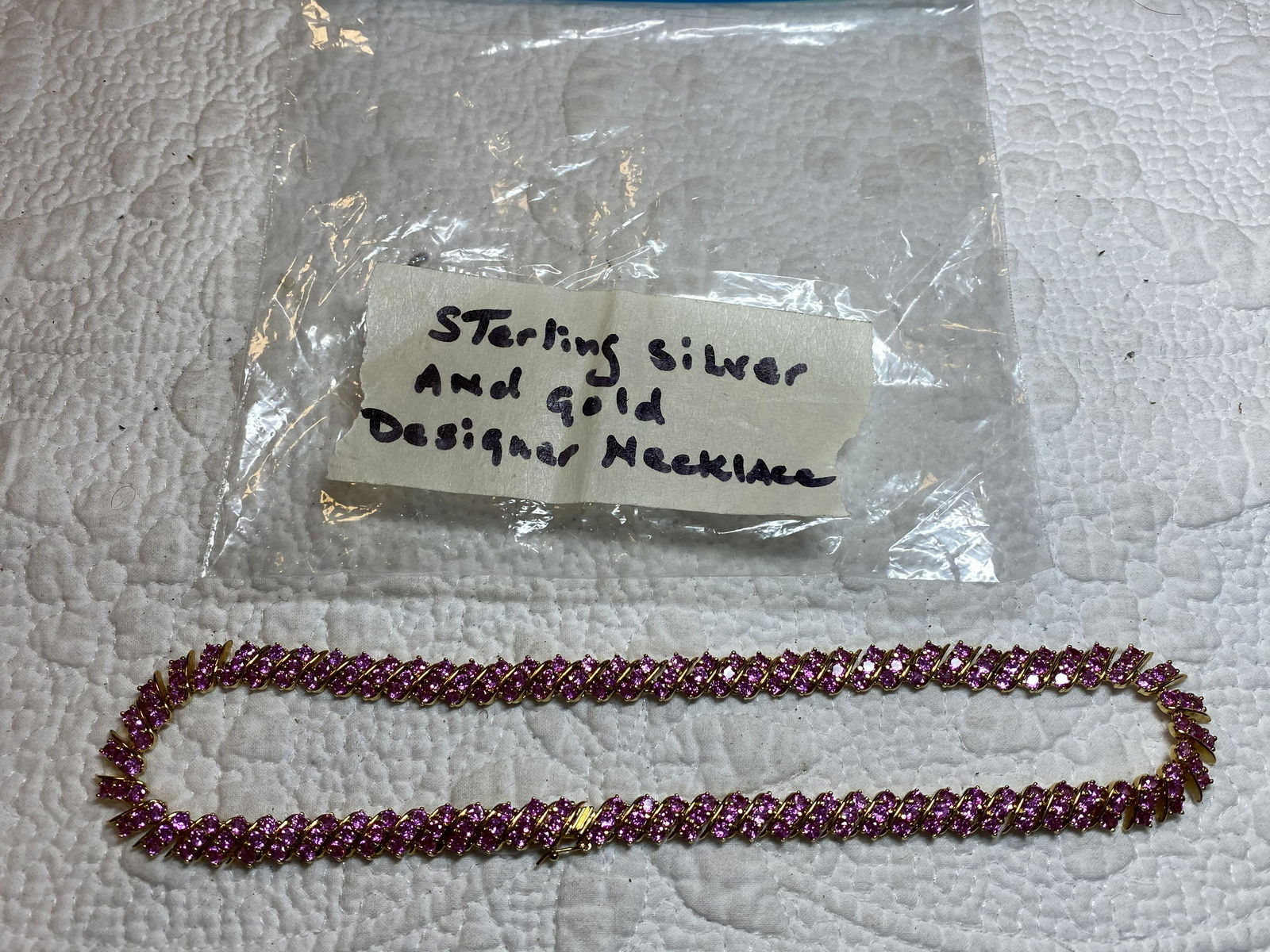BEAUTIFUL STERLING SILVER AND GOLD DESIGNER NECKLACE: BEAUTIFUL STERLING SILVER AND GOLD DESIGNER NECKLACE. HAS RUBY COLORED STONES. A GREAT ADDITION TO YOUR COLLECTION.